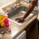 JACKSON, MS - SEPTEMBER 01: Terrence Carter mixes bleach and soap into the water before washing dishes in response to the water crisis on September 01, 2022, in Jackson, Mississippi. The water pressure increased in Carters’ apartment on Wednesday; however, the water is still unsafe to drink. Jackson has been experiencing days without reliable water service after river flooding caused the main treatment facility to fail.
